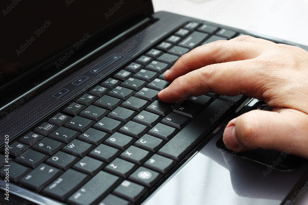 Typing on a laptop computer Typing on a laptop computer