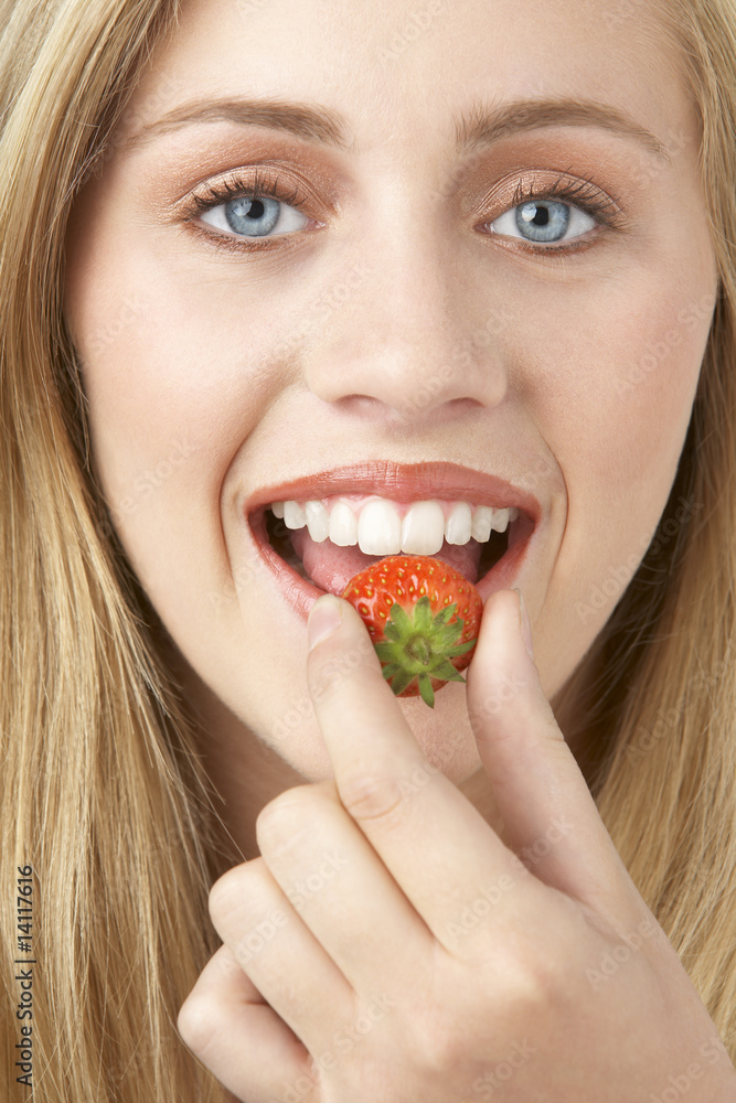 Portrait Of Young Woman Eating Strawberry Portrait Of Young Woman Eating Strawberry