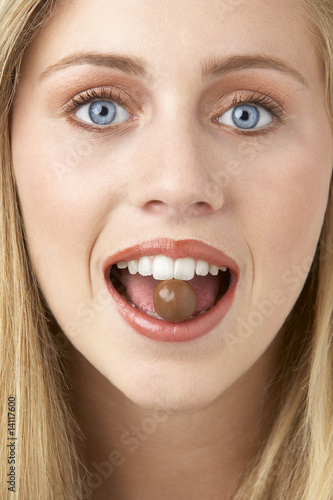 Portrait Of Young Woman Eating Chocolate