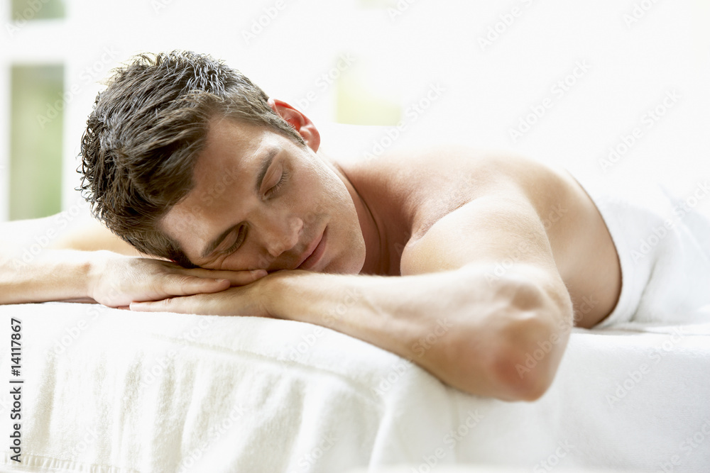 Young Man Relaxing On Massage Table Young Man Relaxing On Massage Table