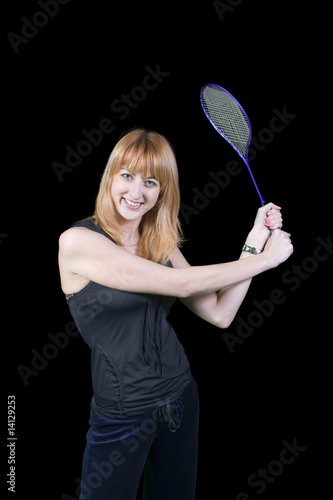 girl standing and holding a racket