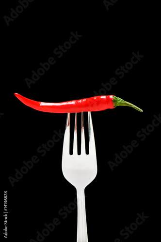 Red pepper isolated on the black background
