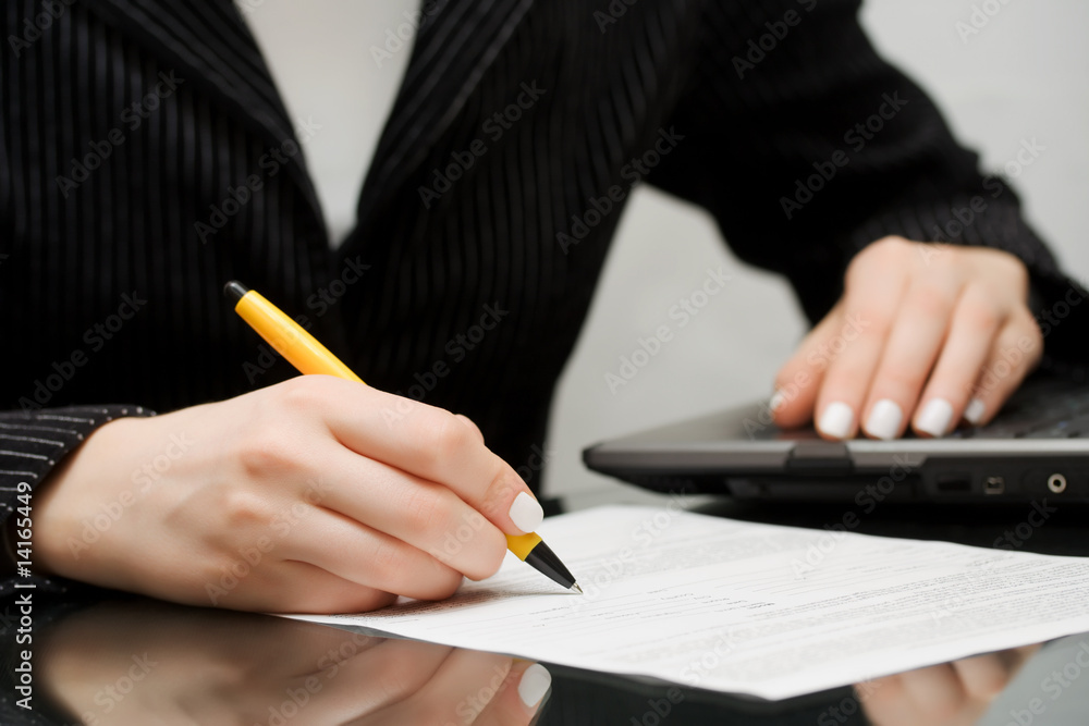 Businesswoman signing the contract. Businesswoman signing the contract.