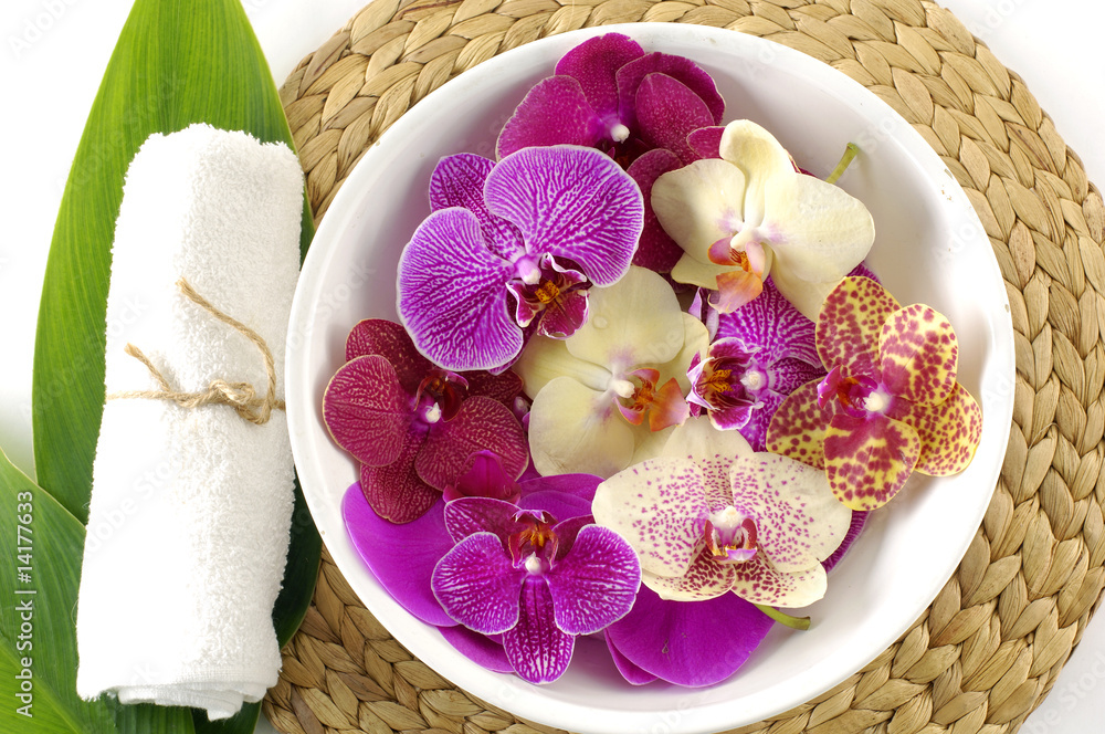 Close up of spa towels, leaf with colorful orchid Close up of spa towels, leaf with colorful orchid