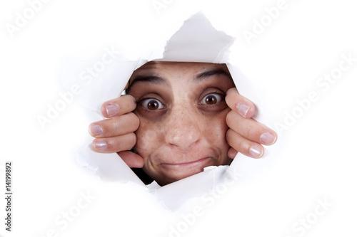 woman peeking behind wal hole