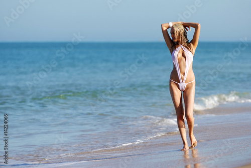 Pretty blonde girl posing on the beach. photo