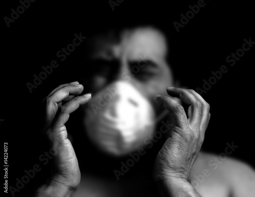 Sick and frightened man with a surgical mask