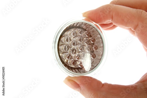 Led bulb in woman's hand on white background