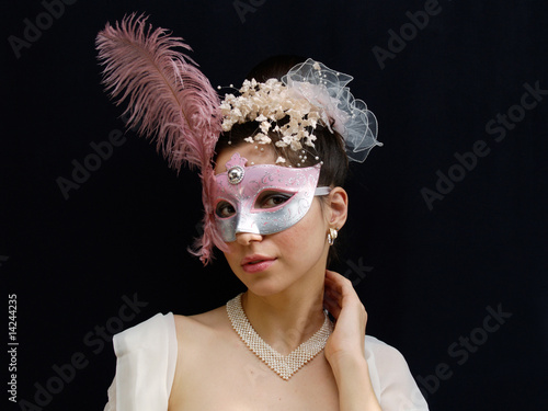 Young lady in mask, hand on her neck, expressing doubt