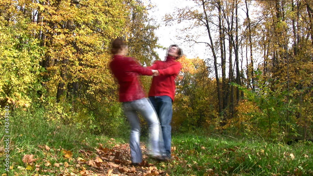 couple rotate in autumn park couple rotate in autumn park