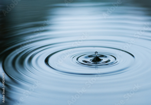Droplet falling in blue water