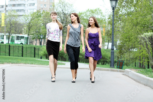 Three girls of the girl-friend walk in park