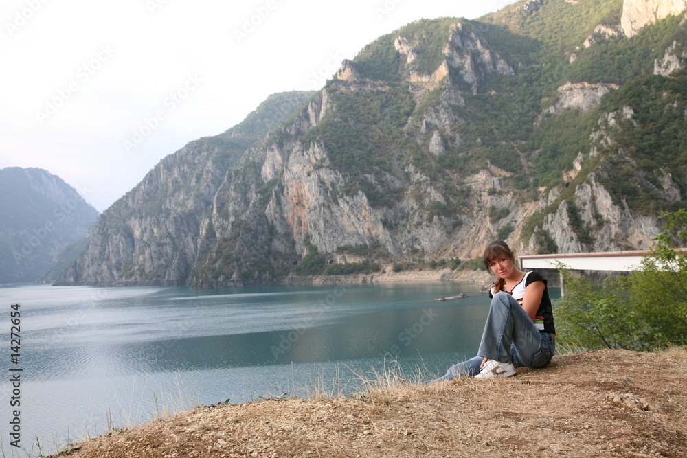 Fototapeta premium Girl on river bank