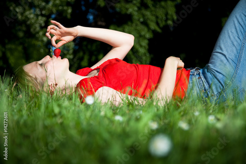 girl with strawberry in the meadow photo