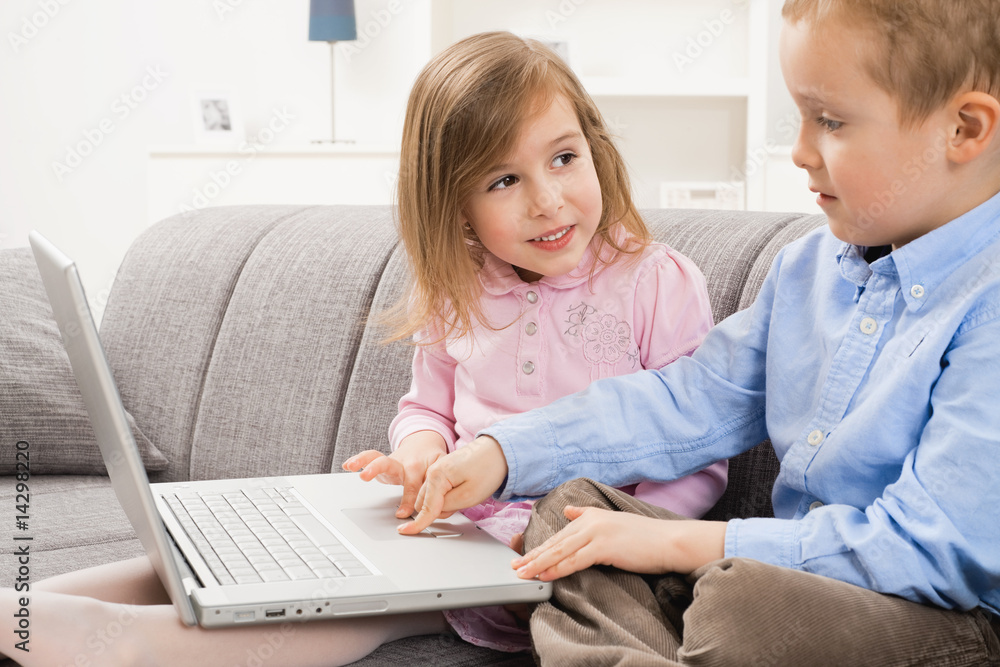 Happy children using laptop computer Happy children using laptop computer