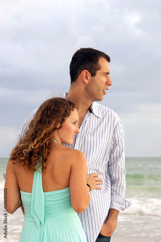 profile portrait of well dressed young couple looking out at the