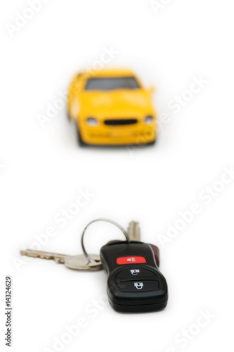 Car keys and car at background isolated on white