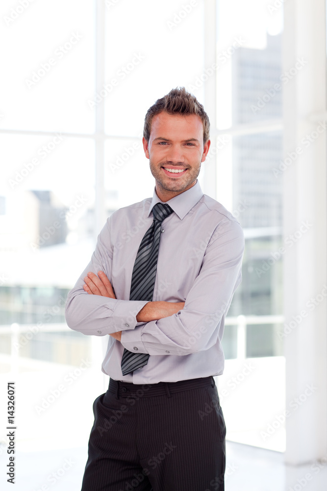 Handsome businessman smiling at the camera Handsome businessman smiling at the camera