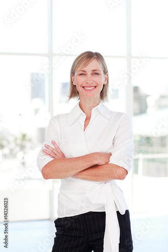 Blonde businesswoman with folded arms