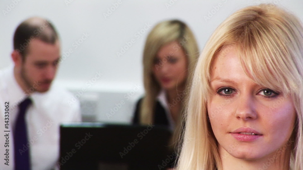 Portrait of a businesswoman with her team in the background