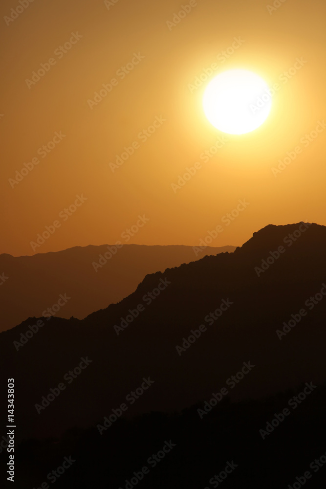 Fototapeta premium Vertical Silhouette Sunrise of Hazy Misty Mountains