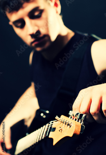 musician tune up the guitar