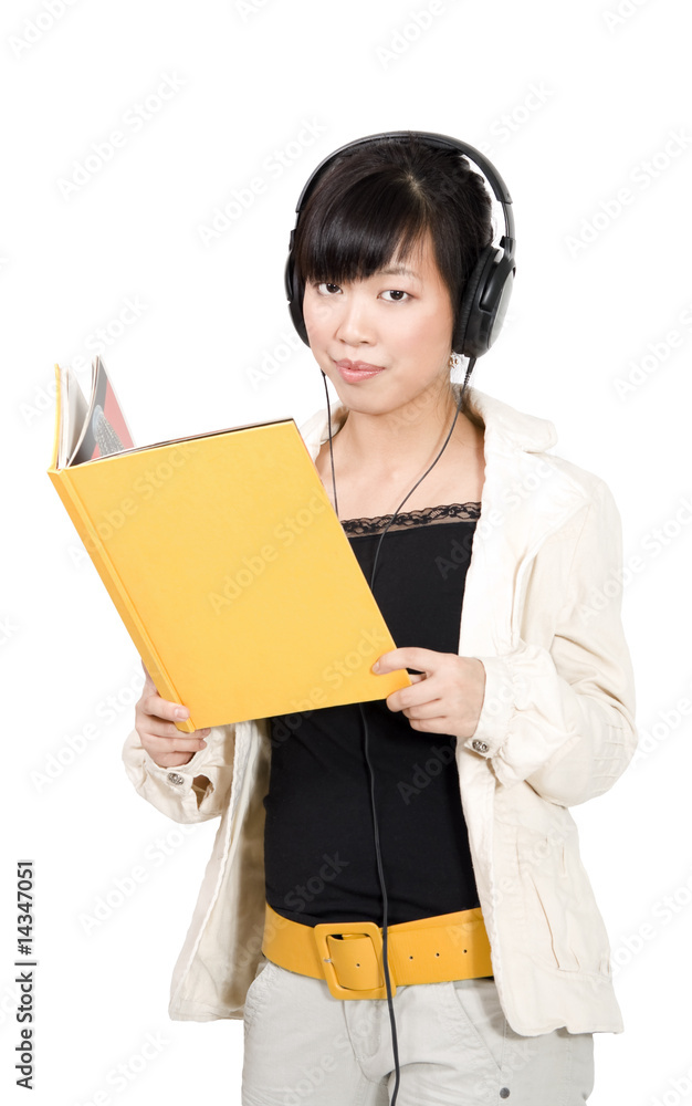 Asian girl in headphones with yellow book Asian girl in headphones with yellow book