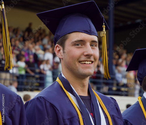Male high school graduate attending graduation ceremony