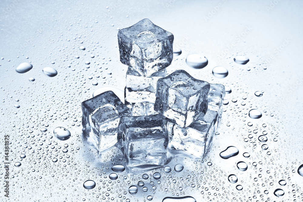 Melting ice cubes on a metal tabletop Melting ice cubes on a metal tabletop