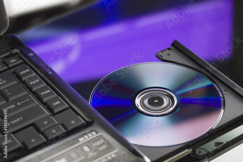 Laptop with a disk dvd. Close up.