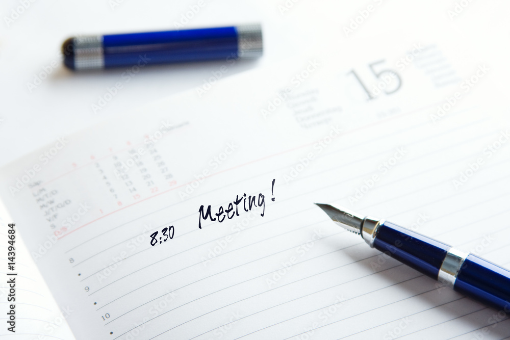 pen on a top of day planner pen on a top of day planner
