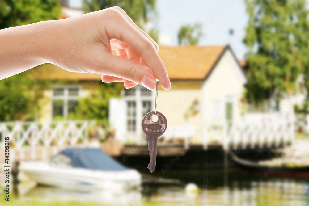 Handing over house key with a new home in the background Stock Photo ...