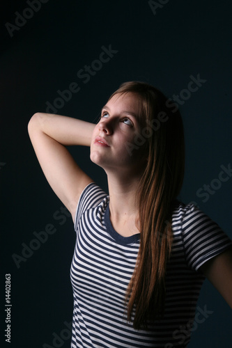petty teen with arm raised as if stretching