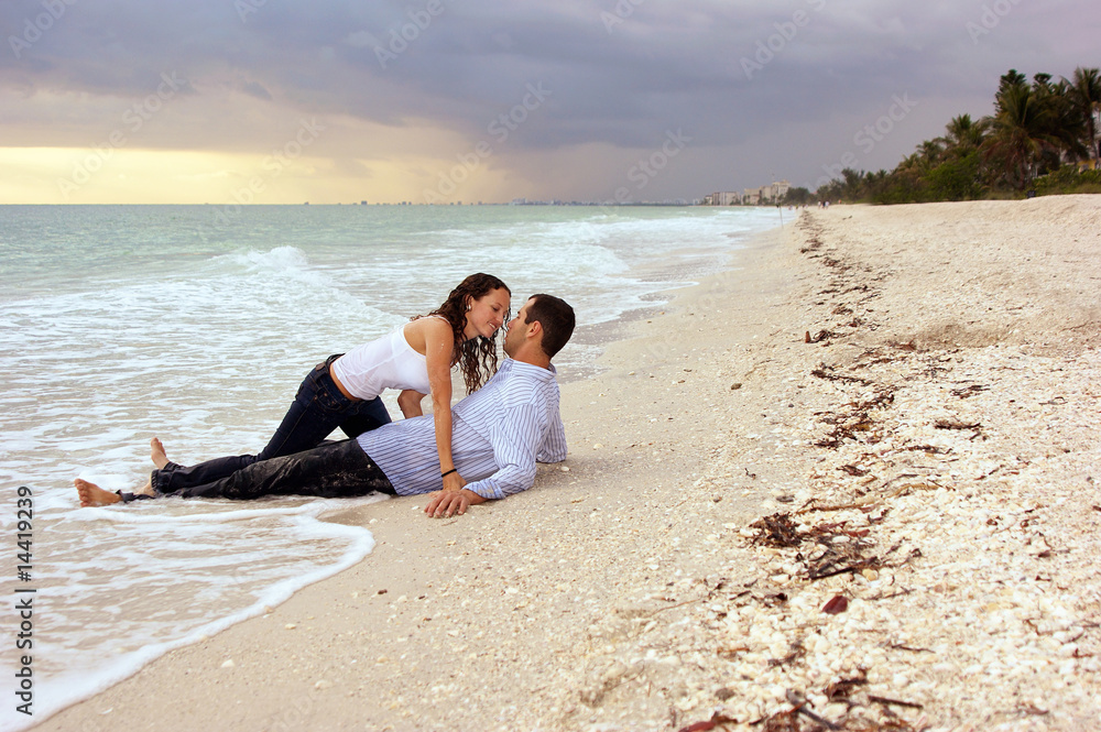 fantasy woman about to kiss man  on beach at sunset