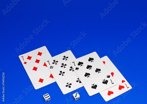 The dice and playing cards on blue background