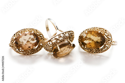 Golden ring and earrings isolated on the white background