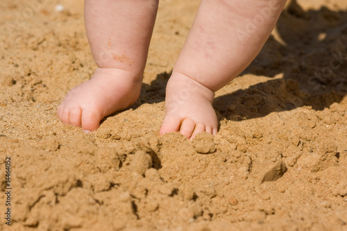 closeup baby's feet with sand