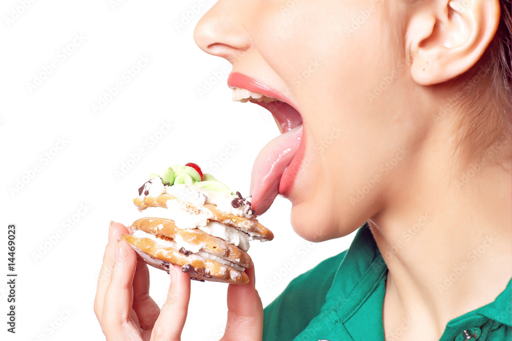 Young pretty woman in green shirt eating cake