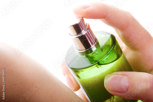 Close-up of a woman spraying her wrist