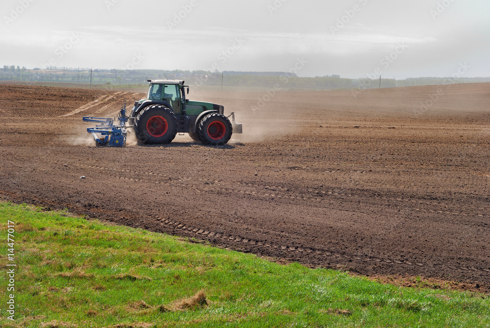 Obraz premium Ploughing tractor