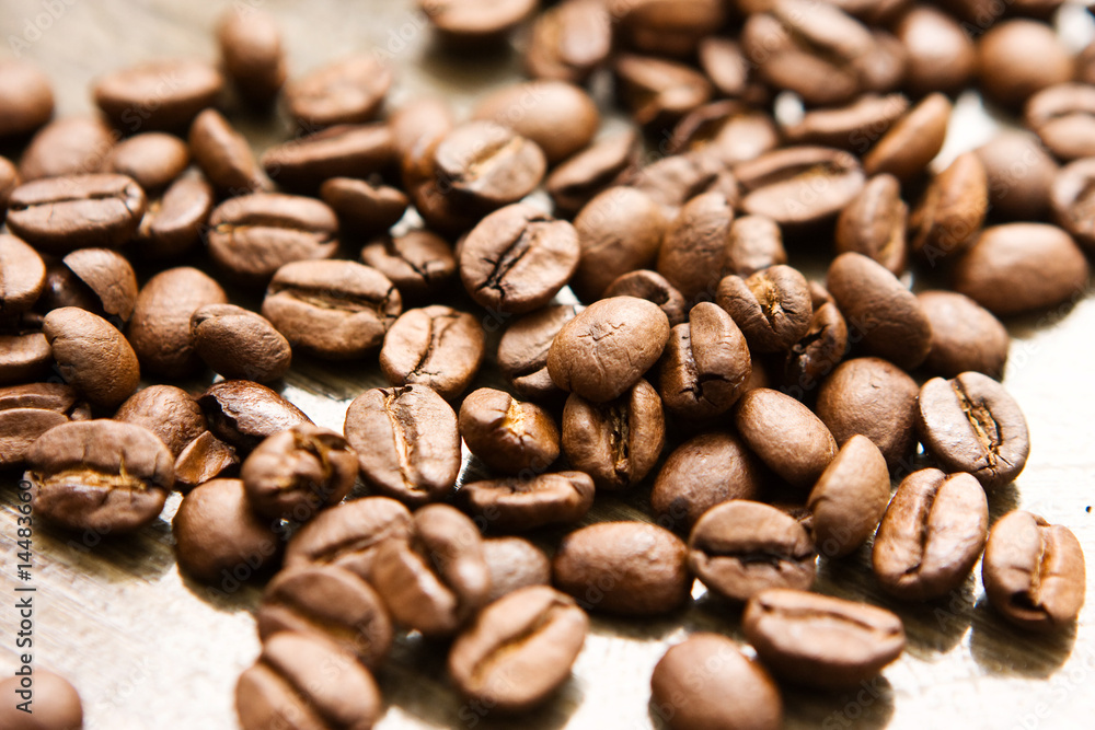 Coffee beans on brown table Coffee beans on brown table