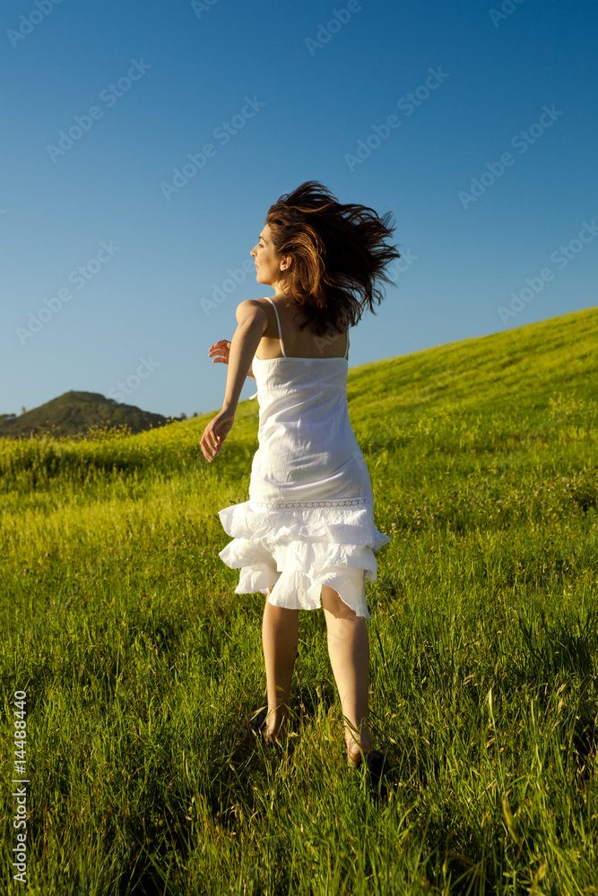 Young woman running on a beautiful springfield Young woman running on a beautiful springfield