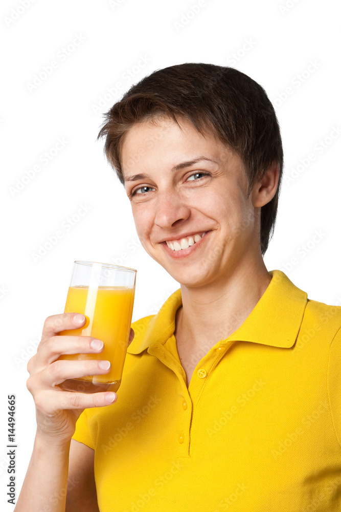 The smiling girl with a glass of orange juice The smiling girl with a glass of orange juice