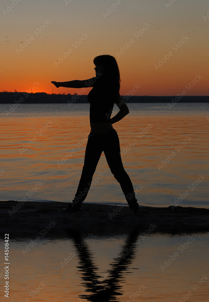 Girl doing exercises on the beach