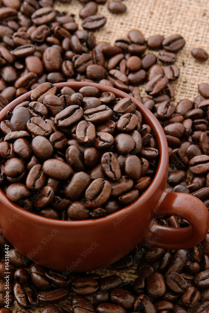 Cup of coffee beans on burlap Cup of coffee beans on burlap