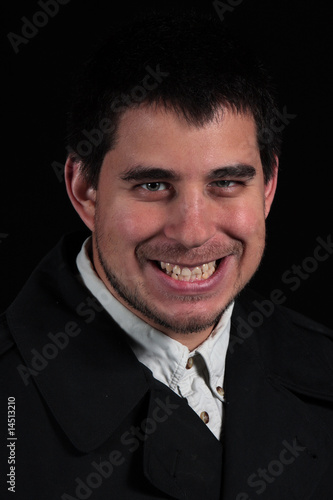 sinister smile of male portrait isolated on black background