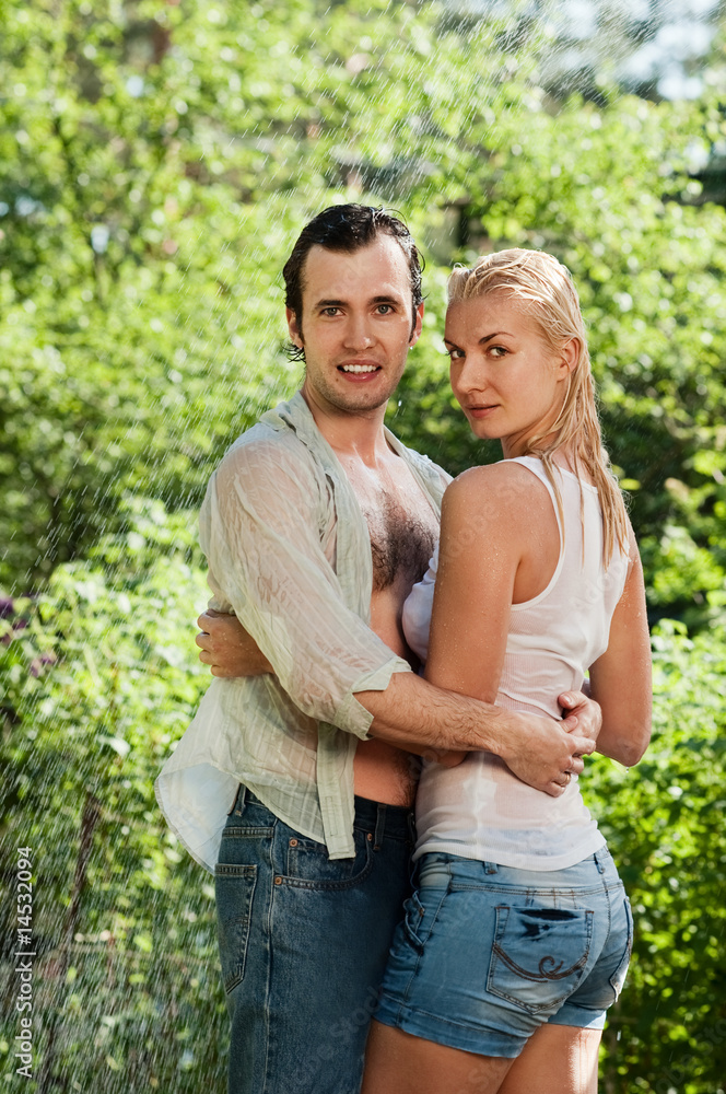 Young couple in love under rain