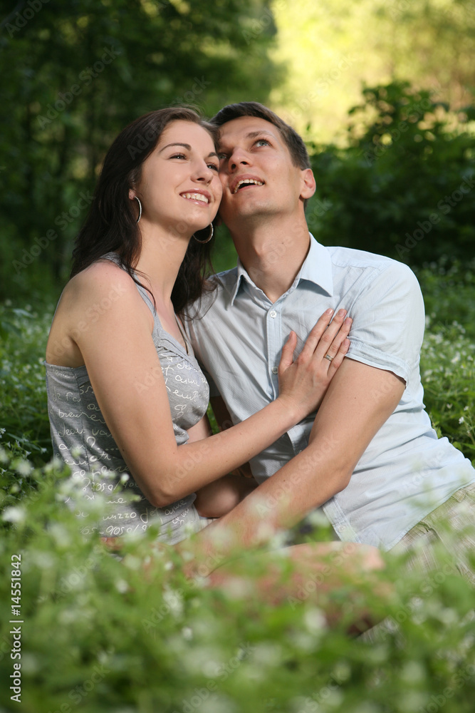 Man and woman sitting on the grass. Man and woman sitting on the grass.