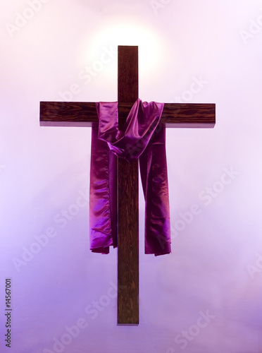 Easter cross with purple sash floating with a glow behind