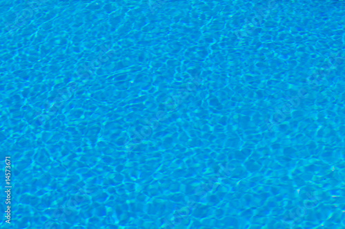 Clear water in the swimming pool. Background texture